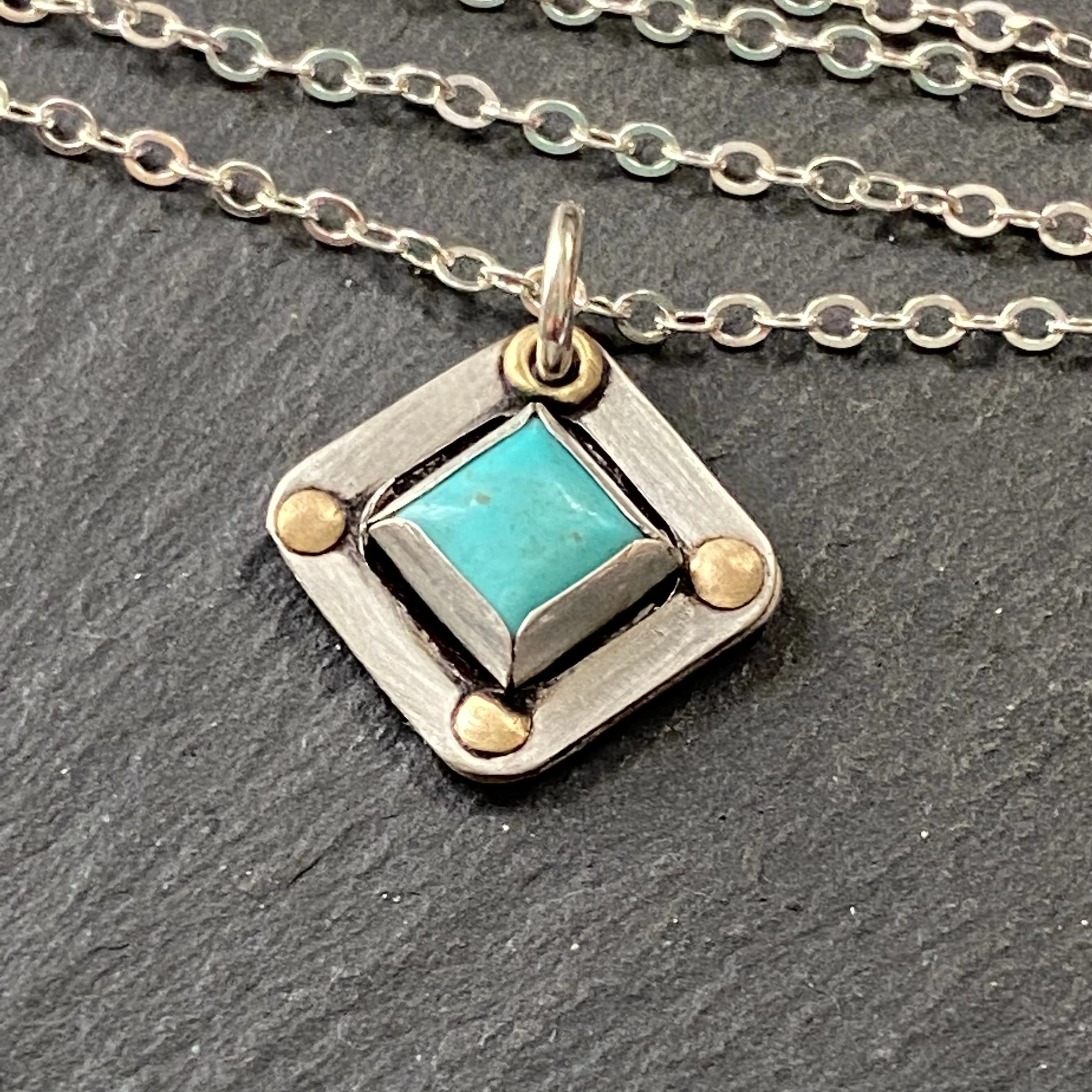 Square Turquoise necklace hand crafted from sterling silver and genuine square Kingman turquoise with golden brass accents