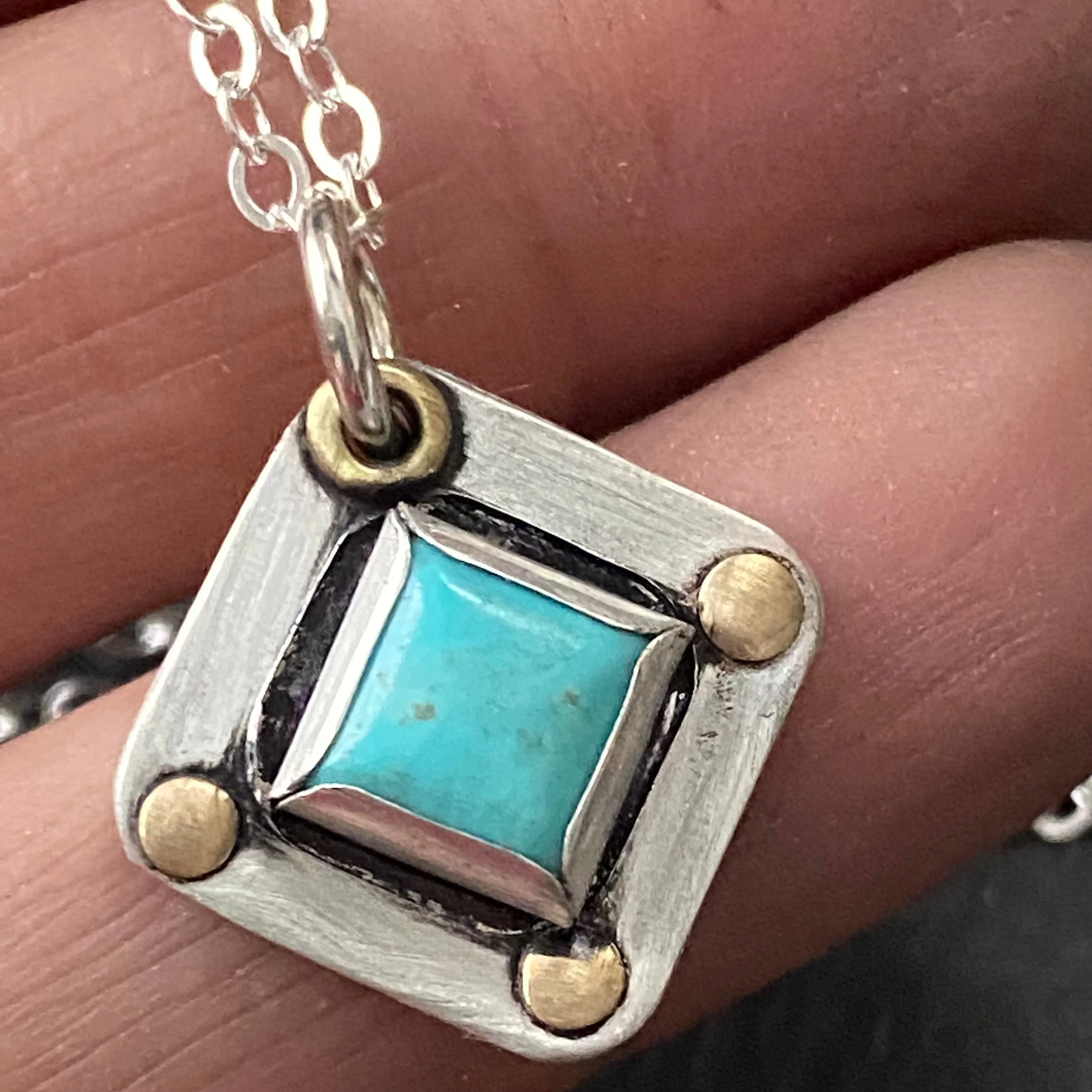 Square Turquoise necklace hand crafted from sterling silver and genuine square Kingman turquoise with golden brass accents