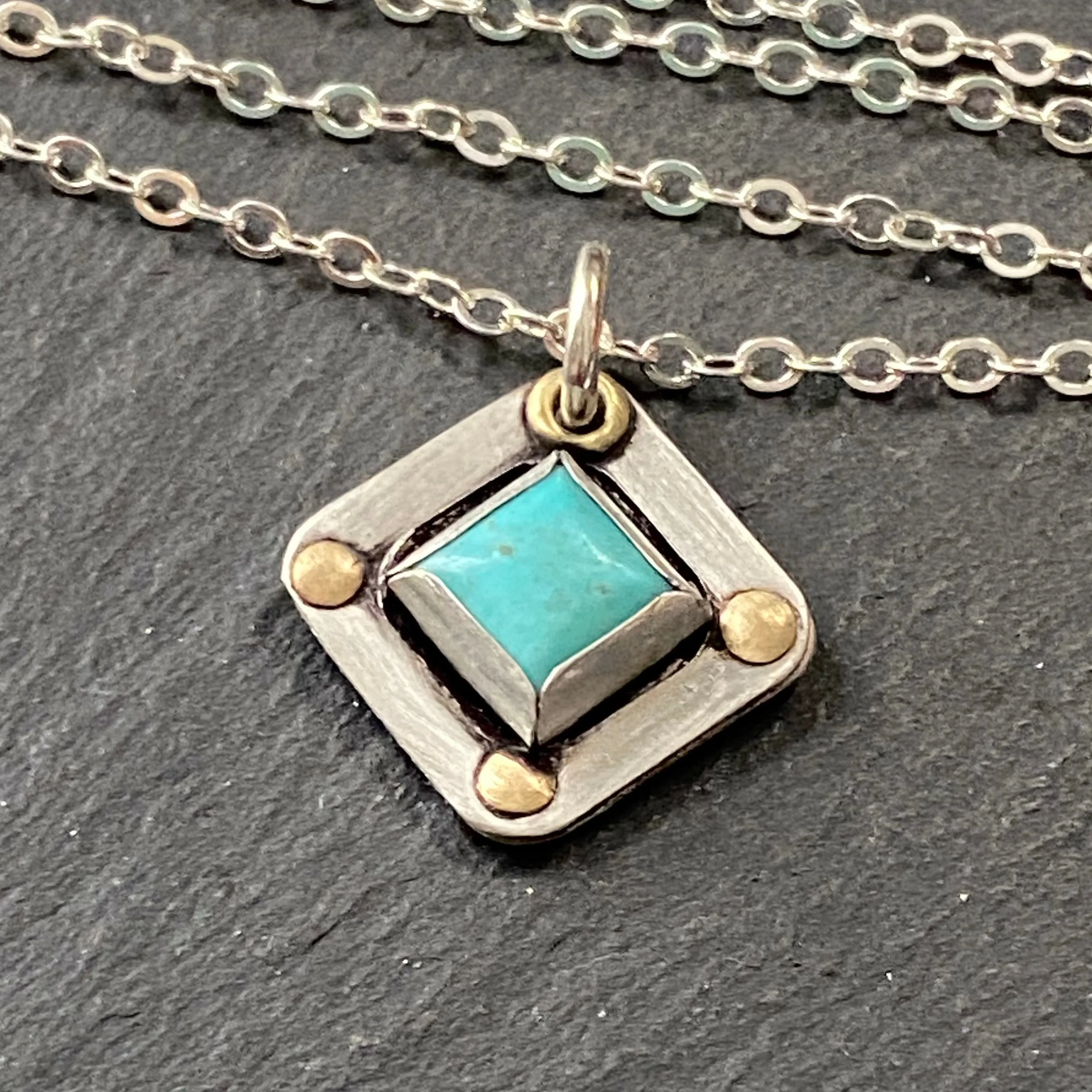 Square Turquoise necklace hand crafted from sterling silver and genuine square Kingman turquoise with golden brass accents